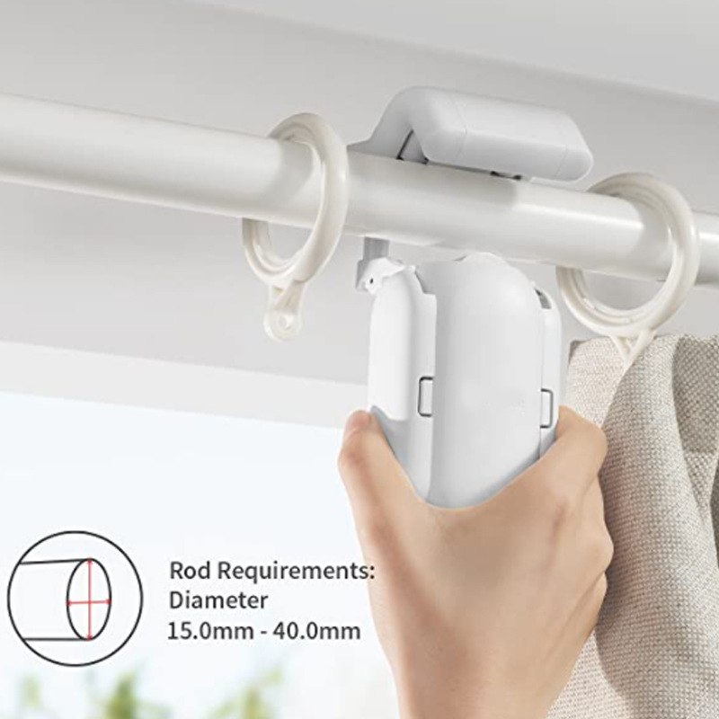 Hand holding a white curtain rod holder against a neutral background