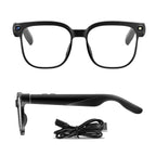 Black smart glasses with charging cable on a white background