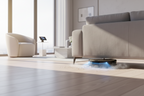 Black and gold round robot vacuum cleaner on a white background