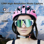 Person wearing a pink and black helmet with colorful goggles against a mountainous background
