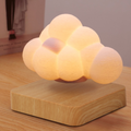 Cloud-shaped lamp on a wooden base with a soft glow