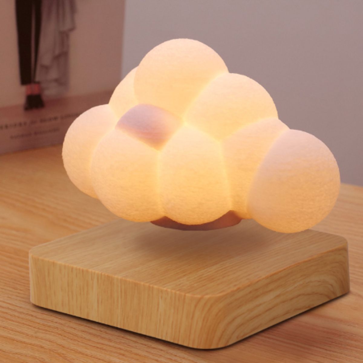 Cloud-shaped lamp on a wooden base with a soft glow