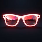 White-framed sunglasses with red-tinted lenses on a white background