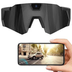 Black goggles with a camera on top, displayed above a smartphone showing a street scene.